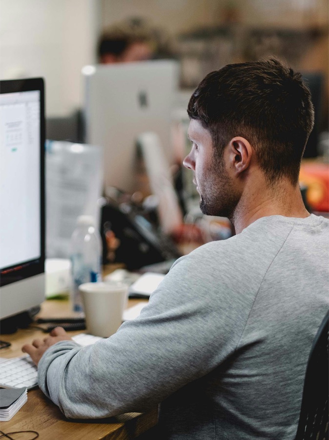 A designer working at a desktop, representing the design work DCI assesses